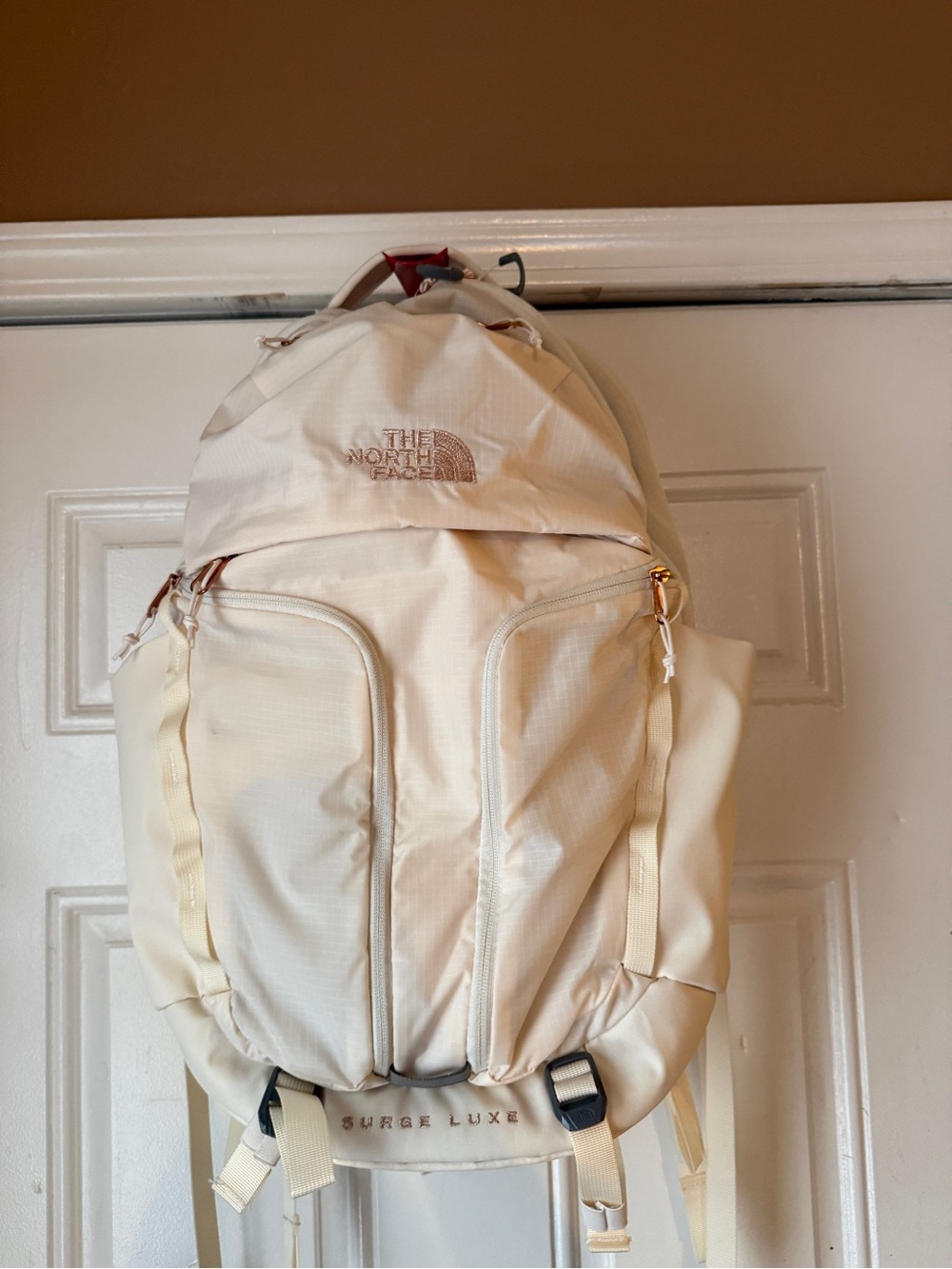 The North Face Surge Luxe Backpack in Cream with Gold Accents